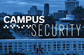 Blue-toned aerial view of a city and campus skyline with large white text reading “Campus Security” across the center. A pedestrian bridge with the University of Kentucky “UK” logo is visible in the foreground.