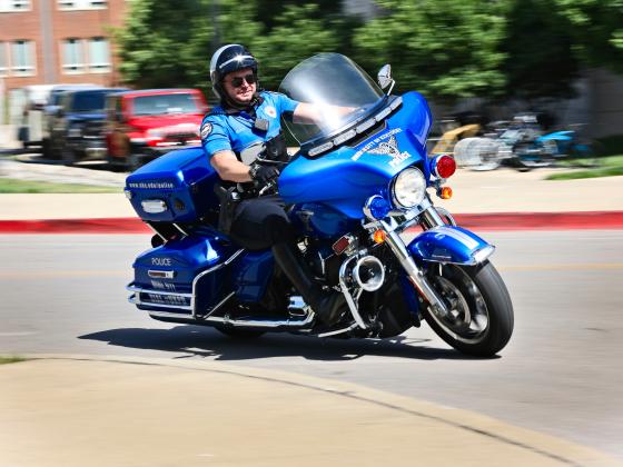 Officer Driving Motorcycle fast around a corner